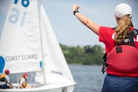 Female guard gave a ready sign for sailing. -- Swabs from the Class of 2019 practice sailing under the guidance of their 2nd Class Cadre at the U.S. Coast Guard Academy July 13, 2015 during Swab Summer. U.S. Coast Guard photo by Petty Officer 2nd Class Cory J. Mendenhall. Original public domain image from Flickr