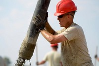 U.S. Air Force Staff Sgt. Millard Morgan, a utilities technician with the South Carolina Air National Guard’s 169th Civil Engineer Squadron at McEntire Joint National Guard Base, S.C., pours mixed concrete for multi-purpose building foundations being constructed in support of a Deployment for Training in Israel, June 30, 2015.