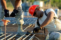 U.S. Air Force Staff Sgt. Jeffrey Cunningham, a heating, ventilation and air-conditioning technician from the South Carolina Air National Guard’s 169th Civil Engineer Squadron at McEntire Joint National Guard Base, S.C., ties rebar in the foundation of a multi-purpose building being constructed in support of a Deployment for Training in Israel, July 5, 2015. 