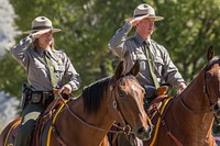 Jackie Sene and Dan Kowalski, members of Yellowstone's Color Guard, salute the flag photo by Neal Herbert. Original public domain image from Flickr