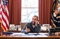 President Barack Obama makes Thanksgiving Day phone calls from the Oval Office to U.S. troops stationed around the world, Nov. 26, 2015.