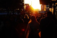 Crowds in city at sunset. Free public domain CC0 photo.