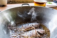 Deep frying fish cooking in a pan. Free public domain CC0 photo.