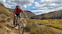 Nancy Odle mountain biking in the fall at Fish Creek on the Manti-Lasal NF in Utah. Forest Service photo by John Odle. Original public domain image from Flickr