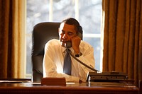 On his first day in office, President Barack Obama speaks with a foreign leader in the Oval Office, Jan. 21, 2009.