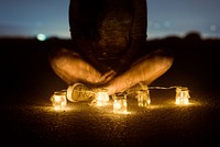 Woman sitting among fairy lights. Free public domain CC0 photo.