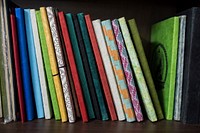 Stacked of colorful notebooks. Free public domain CC0 photo.