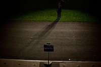 Deputy Director of Oval Office Operations Brian Mosteller's shadow is cast during a ighting test on the South Lawn of the White House, Oct.7, 2009, in preparation for the Astronomy Night event.