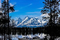 Taken from the main visitor center of Grand Teton National Park. It depicts the Teton range over a lake. Photo by Ryan Stubblebine. Original public domain image from Flickr