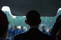 As rain falls, President Barack Obama begins to take part in the annual Memorial Day ceremony at Abraham Lincoln National Cemetery, Elwood, Ill., May 31, 2010.