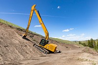 Tower to Chittenden Road Project: a long-boom excavator removes top soil in preparation to widen the road by Jacob W. Frank. Original public domain image from Flickr