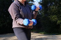 Woman with dumbbells. Free public domain CC0 photo.