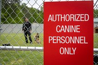 Officer at a training facility for United States Secret Service along with a police dog. Original public domain image from Flickr