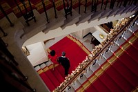 President Barack Obama and First Lady Michelle Obama descend the Grand Staircase as they make their way to a holiday reception on the State Floor of the White House, Dec. 10, 2010.