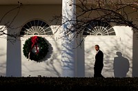 President Barack Obama whistles as he walks along the Colonnade of the White House following a holiday reception, Dec. 14, 2010.