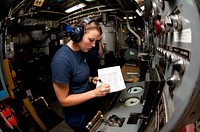 U.S. Coast Guard First Class Cadet Holly Madden logs a reading in the engine room aboard the Coast Guard Cutter Eagle Thursday, June 23, 2011. Madden is one of 137 cadets aboard the Eagle during the 2011 Summer Training Cruise, which commemorates the 75th anniversary of the 295-foot barque. U.S. Coast Guard photo by Petty Officer 1st Class NyxoLyno Cangemi. Original public domain image from Flickr