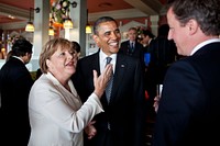 President Barack Obama talks with German Chancellor Angela Merkel and British Prime Minister David Cameron before the start of the working G8 dinner in Deauville, France, May 26, 2011.