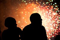 President Barack Obama and First Lady Michelle Obama watch fireworks from the roof of the White House, July 4, 2011.
