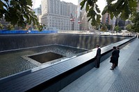 President Barack Obama and First Lady Michelle Obama, along with former President George W. Bush and former First Lady Laura Bush, pause at the North Memorial Pool of the National September 11 Memorial in New York, N.Y., on the tenth anniversary of the 9/11 attacks against the United States, Sunday, Sept. 11, 2011.