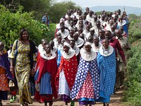 Maasai women at USAID literacy event. In Tanzania, USAID's Empowerment through Literacy Education Access Project (E-LEAP) helps adult Maasai women learn basic Swahili literacy skills, which allows them to have greater access to essential skills. Currently funded through our Education Sector, led by Tom LeBlanc, this program partners with Mwedo (Maasai women development organization) and began in 2007 with 150 Maasai women. Currently, USAID's program has empowered over 2000 Maasai women. The program extends beyond basic Swahili literacy skills and trains the women in business skills, HIV education, and land rights.