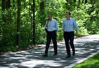 President Barack Obama and Prime Minister David Cameron of the United Kingdom talk as they walk to Laurel Cabin during the G8 Summit at Camp David, Md., May 19, 2012.