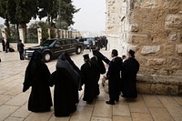 Clergy watch as the President's motorcade prepares to depart the Church of the Nativity in Bethlehem, the West Bank, March 22, 2013.