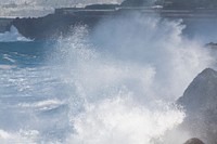 Sea waves crashing into rocks. Free public domain CC0 photo.