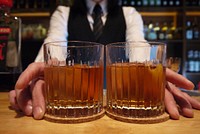 Bartender serving whiskey. Free public domain CC0 photo.