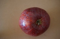 Closeup on red apple on wooden table. Free public domain CC0 photo.