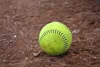 Closeup on softball in soil. Free public domain CC0 photo.