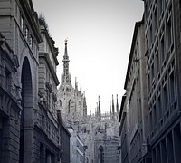 View of buidings, Gothic architectural church and sky in alley in Milan, Italy