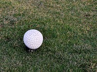 Closeup on golf ball in grass. Free public domain CC0 photo.