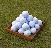 Pile of golf balls on grass field. Free public domain CC0 photo.