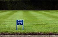 Please keep to the paths sign on grass field. Free public domain CC0 photo.