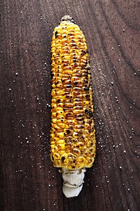 Grilled corn on wooden table. Free public domain CC0 photo.