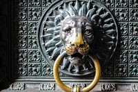 Lion door knocker in brass. Free public domain CC0 photo.