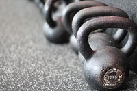 Kettlebells on gym floor. Free public domain CC0 photo.