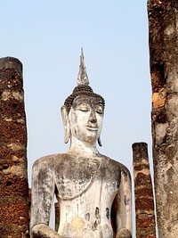 Free ancient Buddha statue between brick tiles public domain CC0 photo.