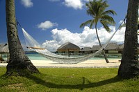 Free rope hammock on beach image, public domain travel CC0 photo.