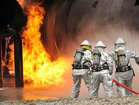 Firemen putting out fire. Free public domain CC0 photo.