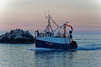 Sailing fishing boat during sunset. Free public domain CC0 photo.