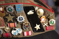 Military pins on hat. Free public domain CC0 photo.