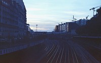 Free view of rail tracks with train station during sunset photo, public domain CC0 image.