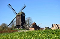 Rustic windmill building in the countryside. Free public domain CC0 image.