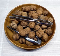 Walnuts with nutcracker in a bowl. Free public domain CC0 image. 