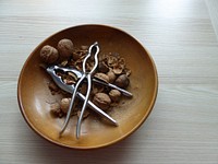 Walnuts with nutcracker in a bowl. Free public domain CC0 image. 