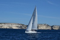 Sailing on laser class sailboat. Free public domain CC0 photo.