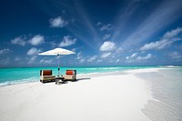 Sandbank beach with empty chairs. Free public domain CC0 image.
