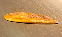 Closeup on surfboard on beach. Free public domain CC0 photo.