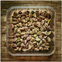 Pistachio nuts in glass bowl. Free public domain CC0 photo.
